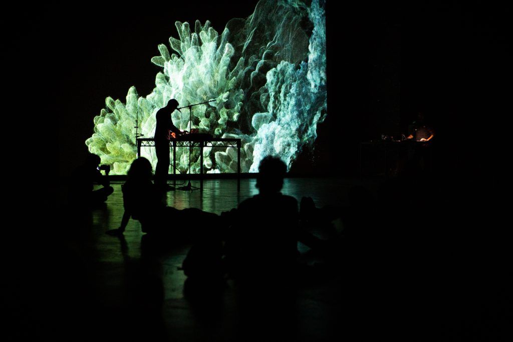 Visuals of an underwater setting projected on to a screen.